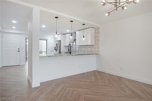 kitchen featuring stainless steel refrigerator with ice dispenser, light parquet flooring, white cabinets, hanging light fixtures, and an inviting chandelier