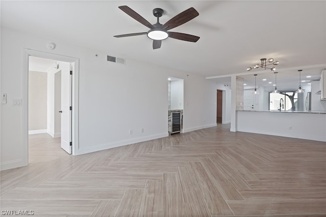 unfurnished living room with beverage cooler, light parquet floors, and ceiling fan