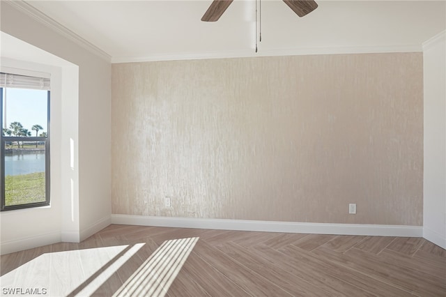 spare room with light parquet floors, crown molding, ceiling fan, and a water view