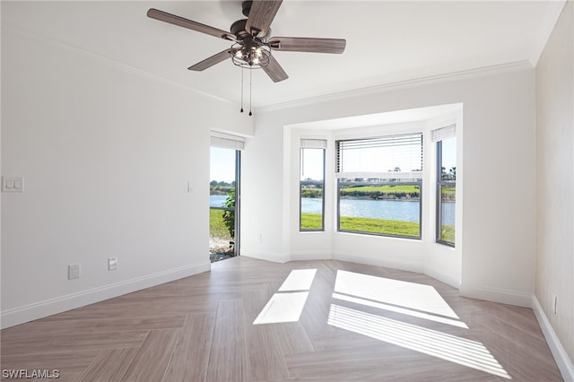 spare room with crown molding, light parquet flooring, a water view, and ceiling fan