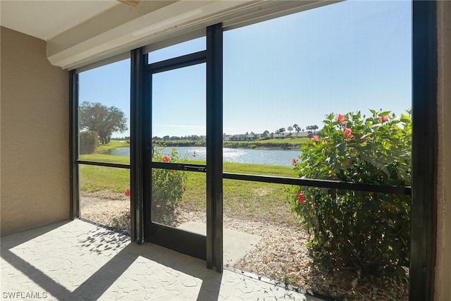 unfurnished sunroom with a water view