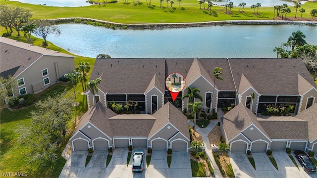 birds eye view of property with a water view