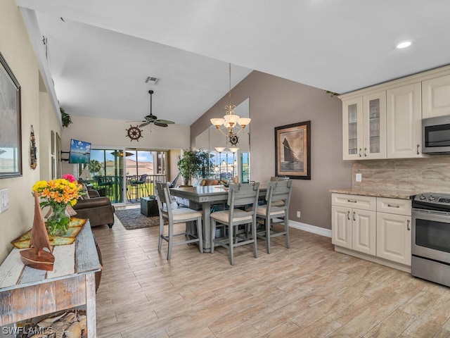 interior space with light stone countertops, ceiling fan with notable chandelier, appliances with stainless steel finishes, light hardwood / wood-style flooring, and tasteful backsplash