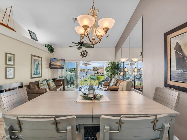 dining room featuring ceiling fan with notable chandelier