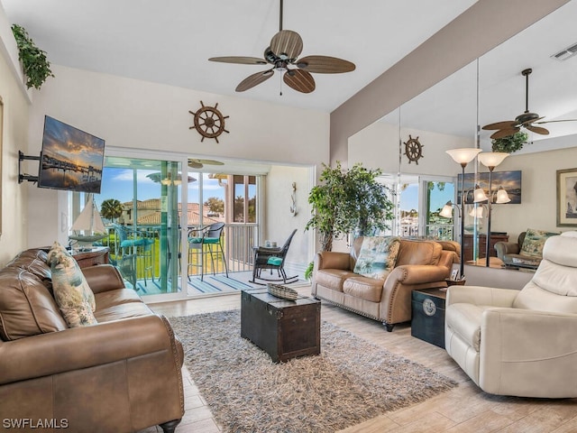 living room featuring light hardwood / wood-style floors and ceiling fan