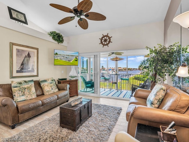 living room with light hardwood / wood-style floors, ceiling fan, and lofted ceiling