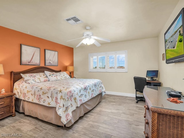 bedroom with light hardwood / wood-style floors and ceiling fan