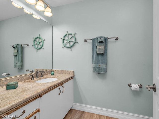 bathroom featuring hardwood / wood-style flooring and vanity