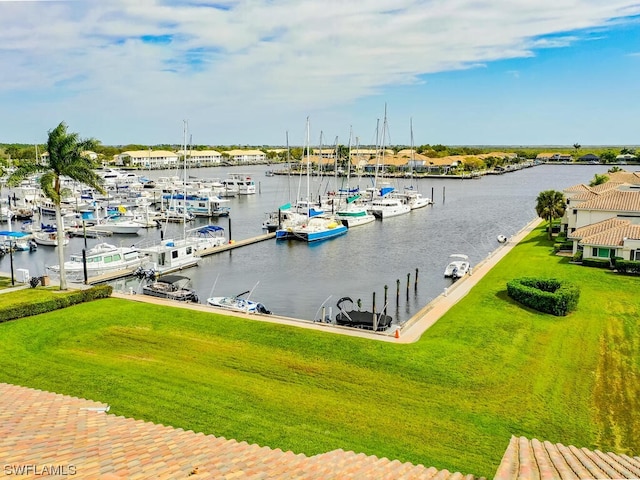 view of dock featuring a lawn and a water view