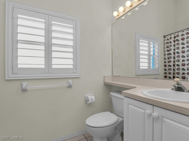 bathroom featuring vanity, tile floors, and toilet