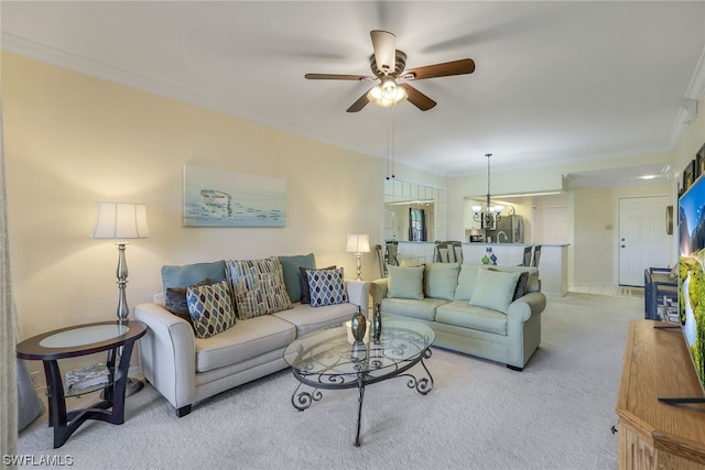 carpeted living room with crown molding and ceiling fan with notable chandelier