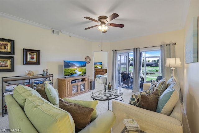 carpeted living room featuring ceiling fan and crown molding