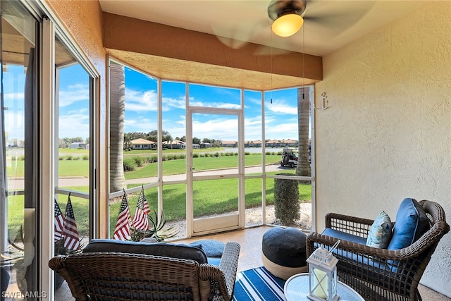 sunroom / solarium featuring ceiling fan