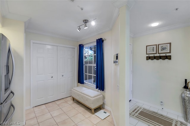 interior space featuring rail lighting and crown molding