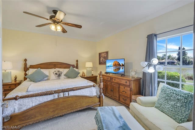 bedroom with light carpet and ceiling fan