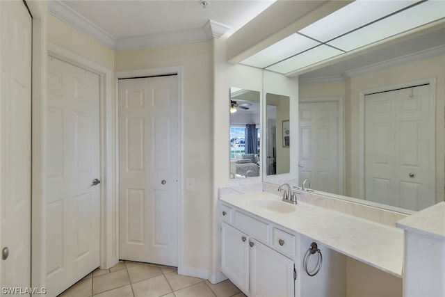 bathroom featuring tile floors, ornamental molding, vanity, and ceiling fan