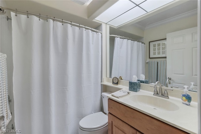 bathroom with vanity, toilet, and ornamental molding