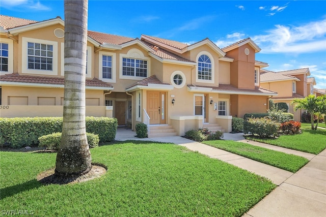 view of front of house featuring a front yard and a garage