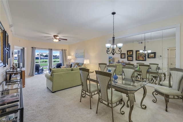 dining room with light colored carpet, ornamental molding, and ceiling fan with notable chandelier