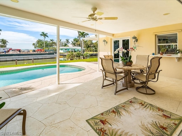 view of swimming pool featuring a patio area and ceiling fan