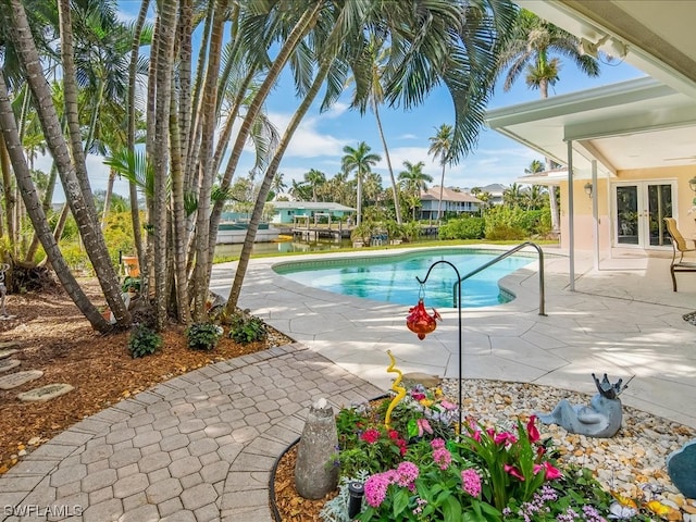 view of swimming pool with a patio area and french doors