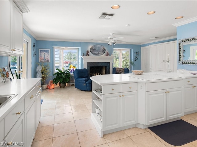 kitchen with light tile floors, plenty of natural light, white cabinetry, and ceiling fan