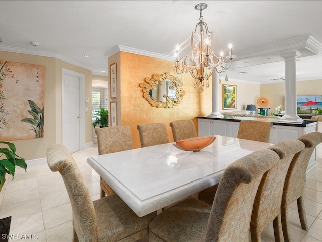 dining area with an inviting chandelier, crown molding, ornate columns, and light tile floors