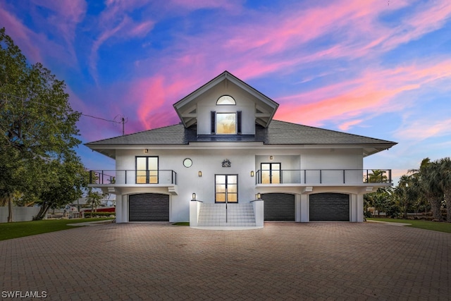 view of front of home with a balcony and a garage