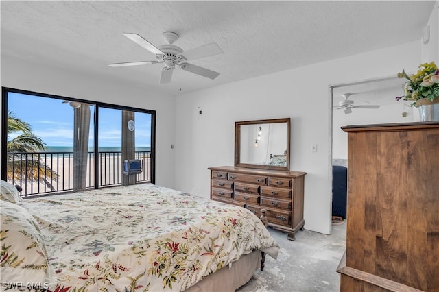 bedroom featuring access to outside, a textured ceiling, ceiling fan, and a water view