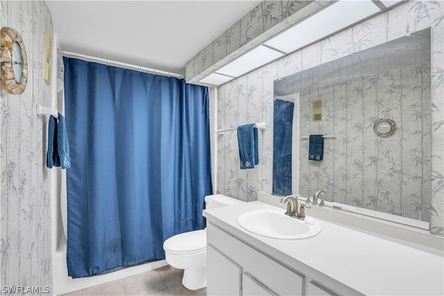 bathroom featuring tile floors, toilet, and vanity with extensive cabinet space