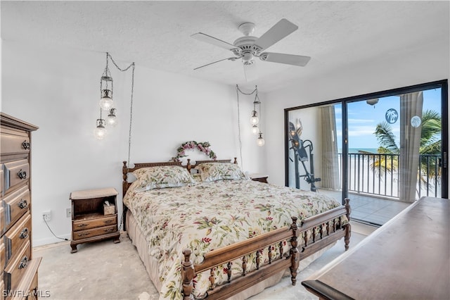 carpeted bedroom with a textured ceiling, ceiling fan, and access to exterior