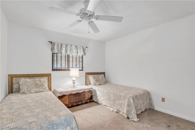 bedroom featuring ceiling fan and light carpet