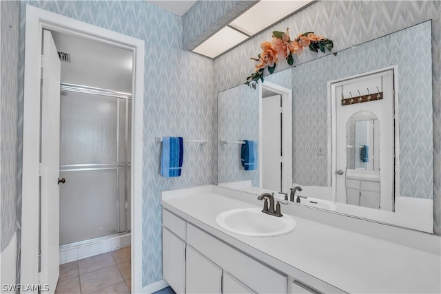 bathroom featuring a shower with door, tile flooring, and oversized vanity