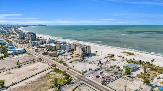 birds eye view of property with a view of the beach and a water view