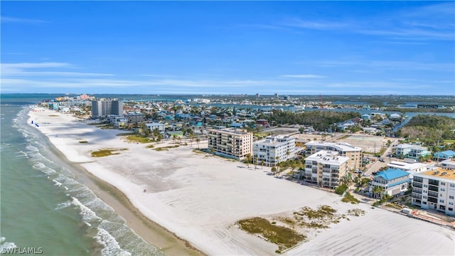 birds eye view of property with a view of the beach and a water view