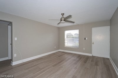 unfurnished room featuring ceiling fan and dark wood-type flooring