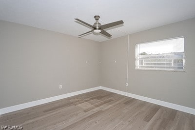 unfurnished room featuring dark hardwood / wood-style floors and ceiling fan