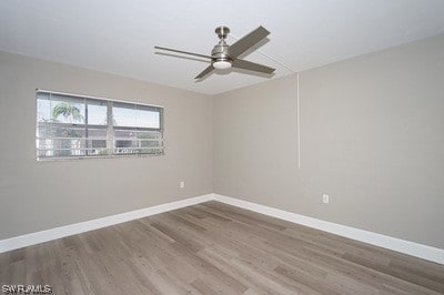 unfurnished room featuring dark hardwood / wood-style flooring and ceiling fan