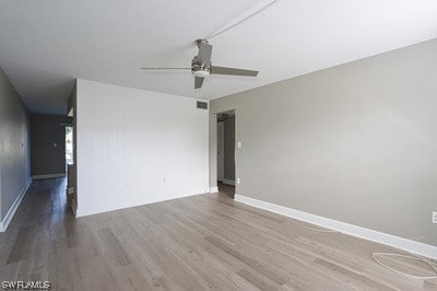 empty room featuring ceiling fan and dark hardwood / wood-style flooring