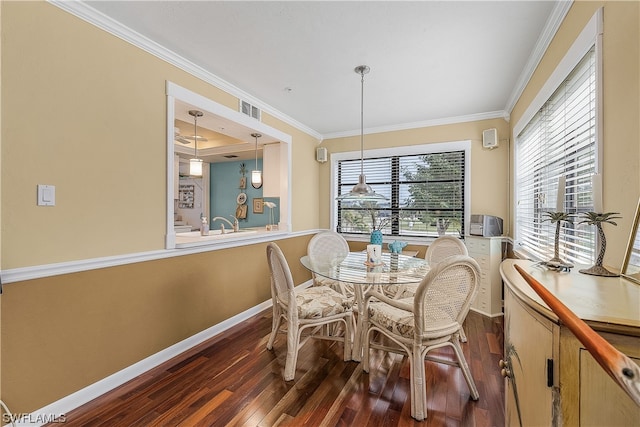 dining room featuring dark hardwood / wood-style floors and crown molding