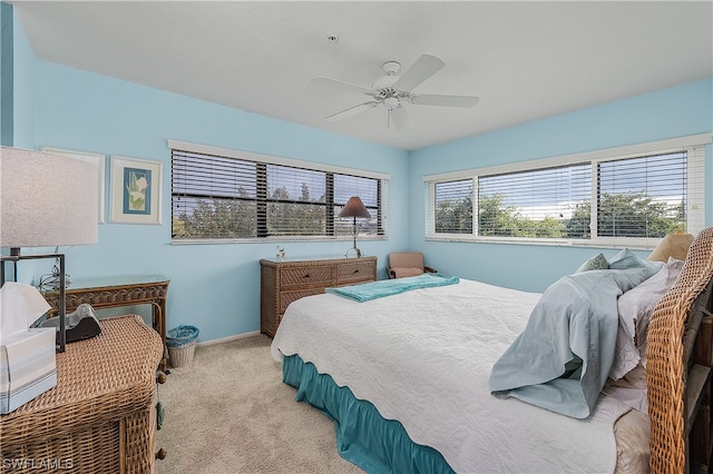 bedroom featuring light carpet and ceiling fan