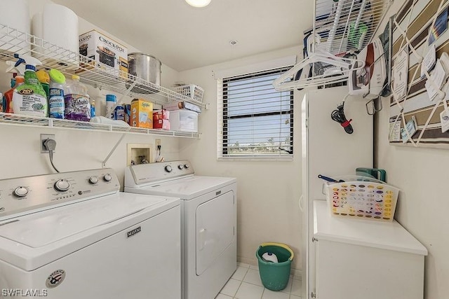 laundry area featuring light tile floors, washer and clothes dryer, hookup for an electric dryer, and hookup for a washing machine