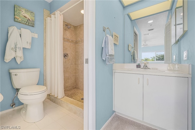 bathroom featuring vanity, a tile shower, tile floors, and toilet