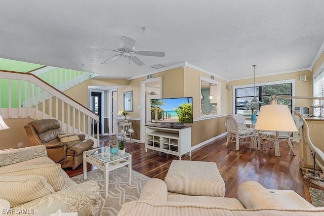 living room featuring dark wood-type flooring, ornamental molding, and ceiling fan