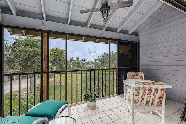 sunroom / solarium with lofted ceiling and ceiling fan