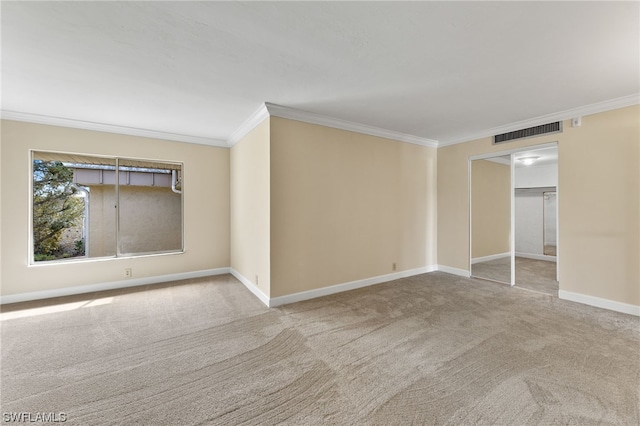 unfurnished room featuring light colored carpet, crown molding, visible vents, and baseboards