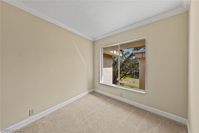 unfurnished room with baseboards, ornamental molding, and carpet