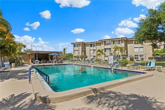 pool with fence and a patio area