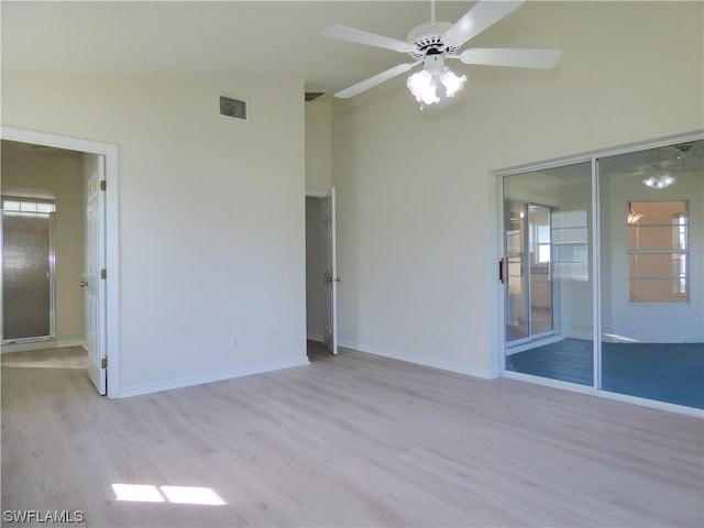 spare room with vaulted ceiling, ceiling fan, and light hardwood / wood-style floors