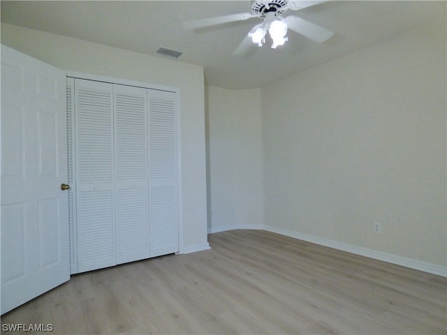 unfurnished bedroom featuring a closet, ceiling fan, and light wood-type flooring